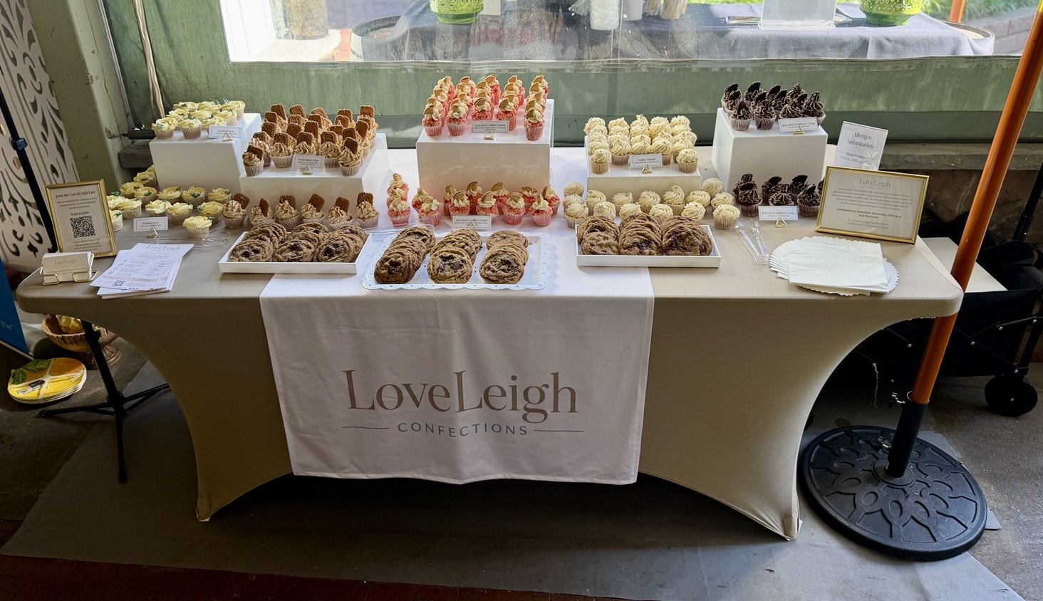LoveLeigh Confections dessert table arranged with cupcakes and cookies